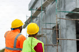Construction managers looking at plans